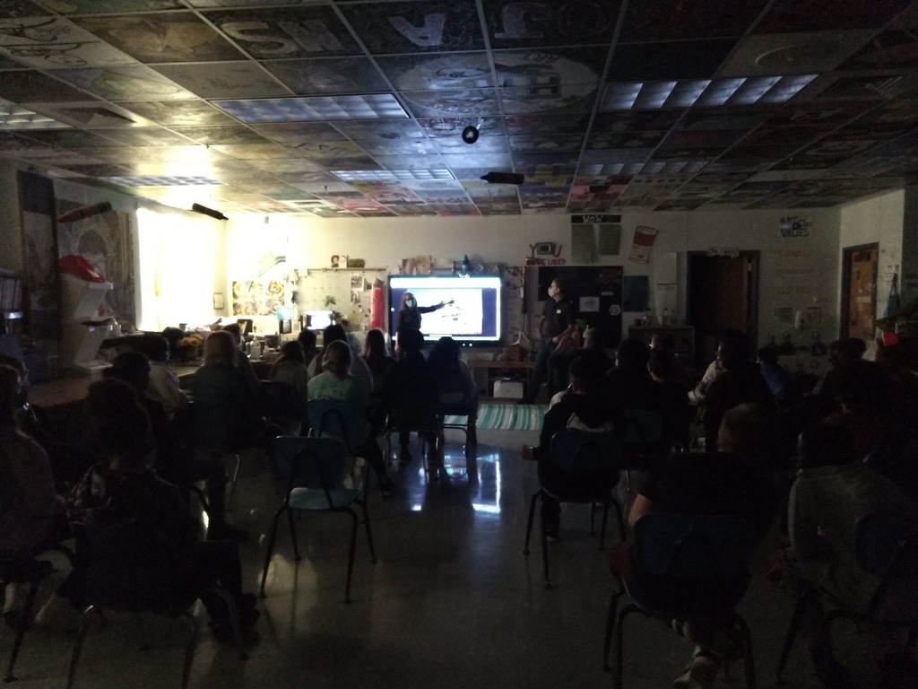 Guest speakers talking with a class.